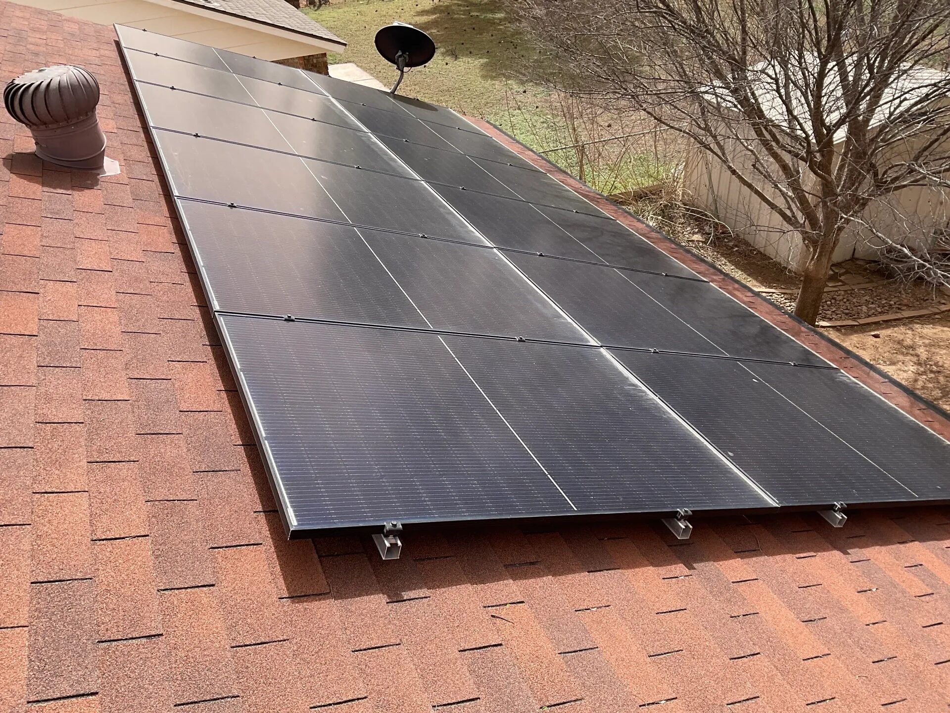 Visible rooftop solar panels and surrounding roof context